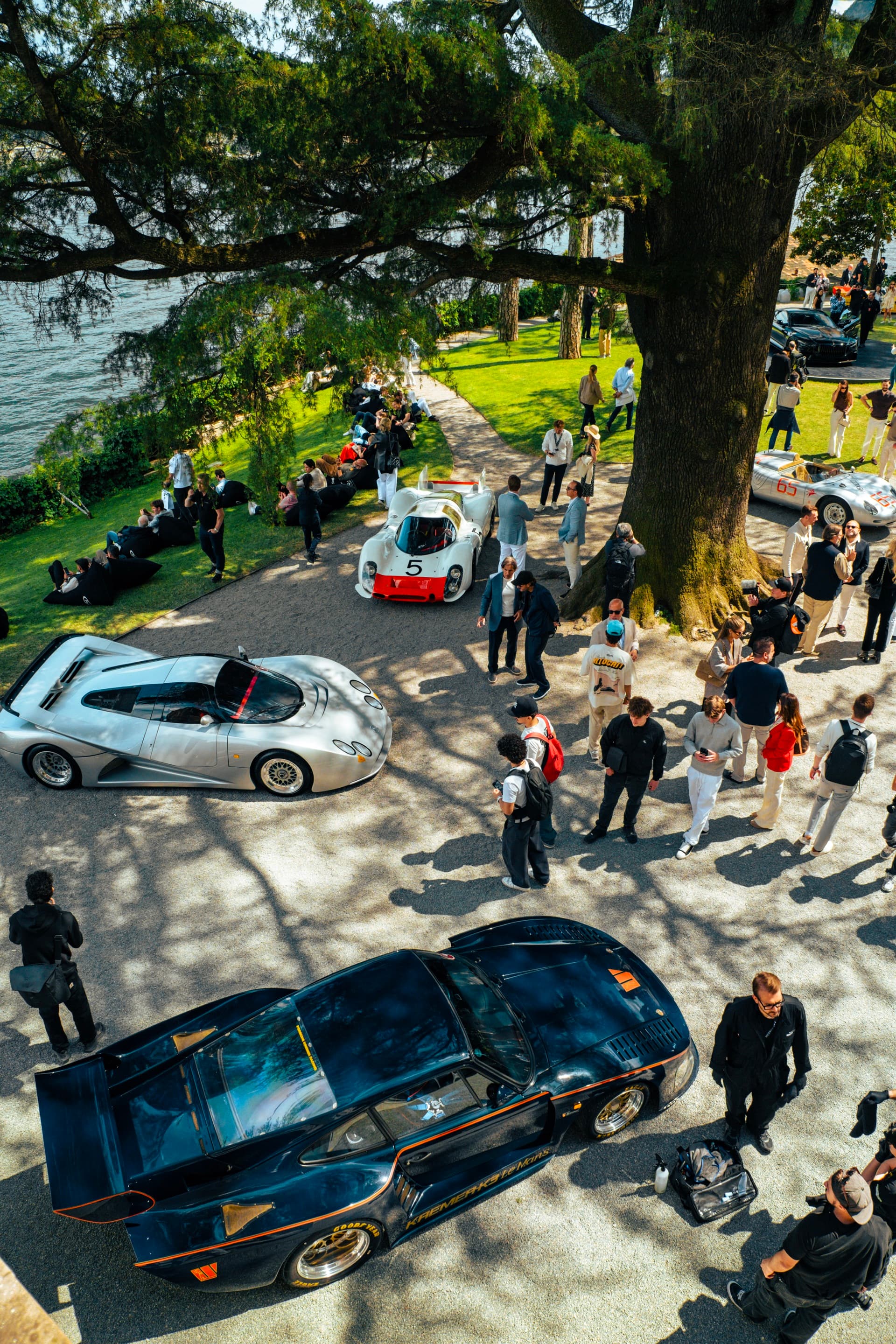 Aerial - Le Mans and prototype racing cars on the lakeside path