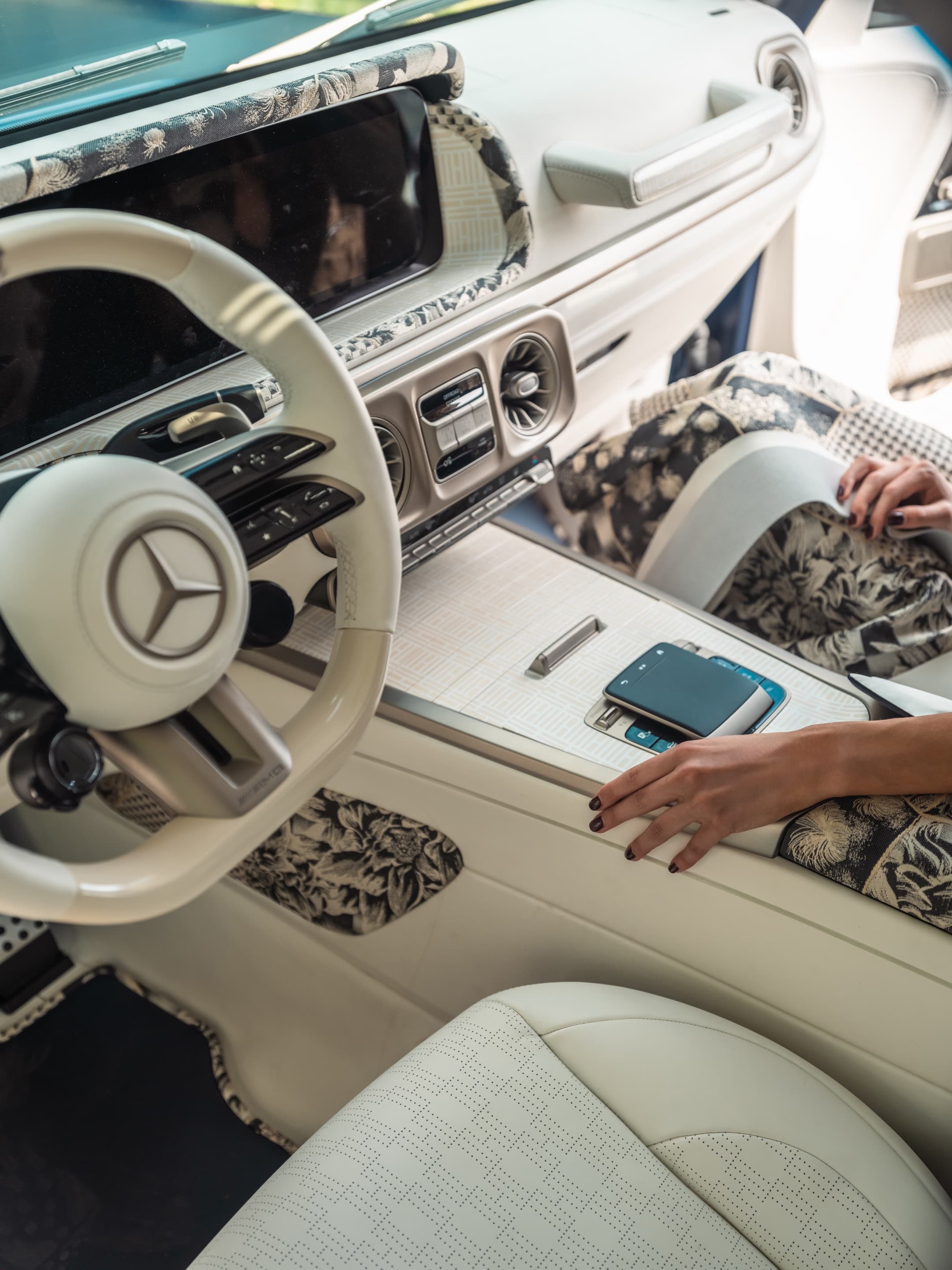 Cockpit detail - Mercedes wheel, botanical jacquard, hand at rest
