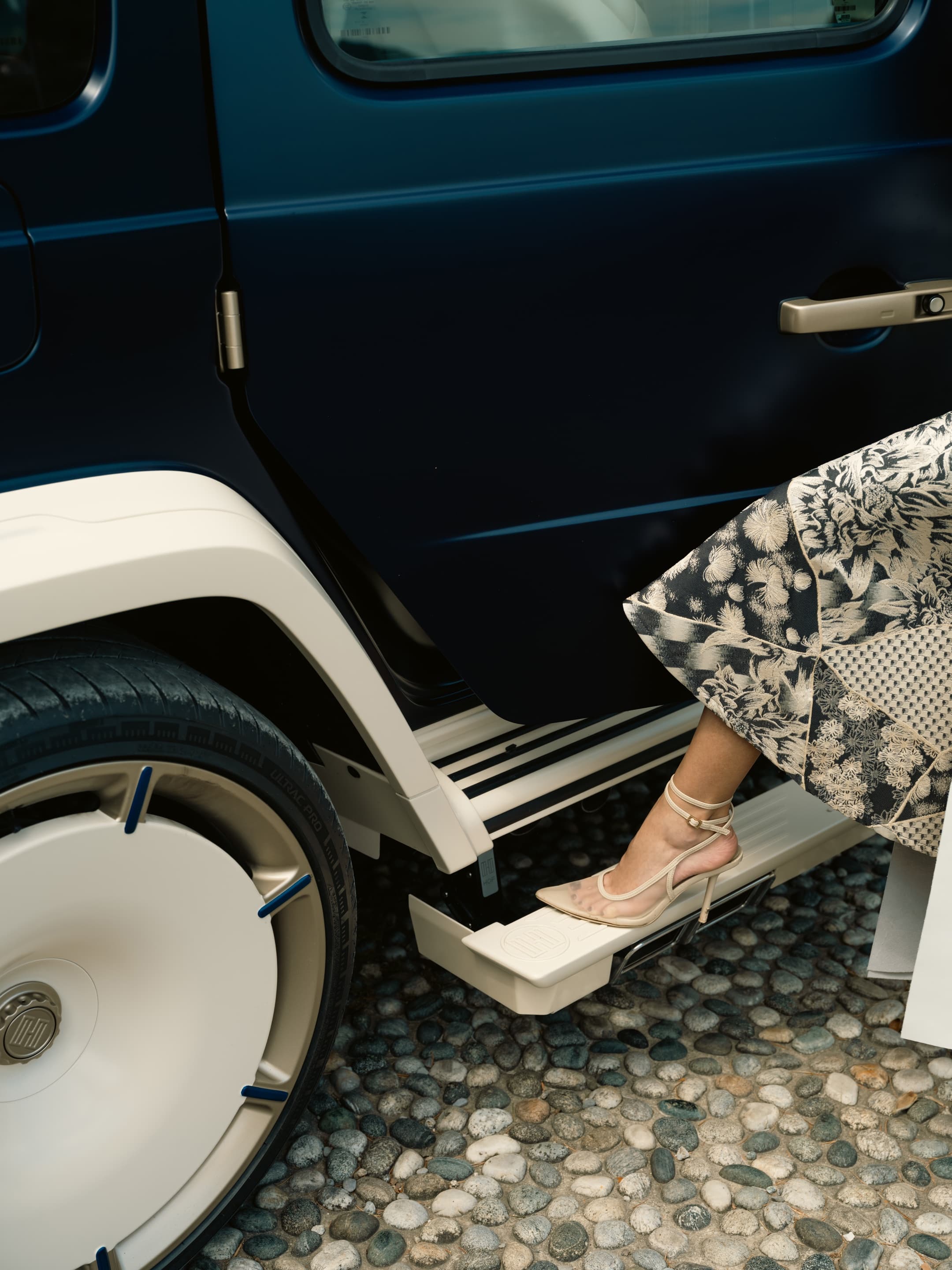 Detail - heel on running board, navy car, floral couture skirt