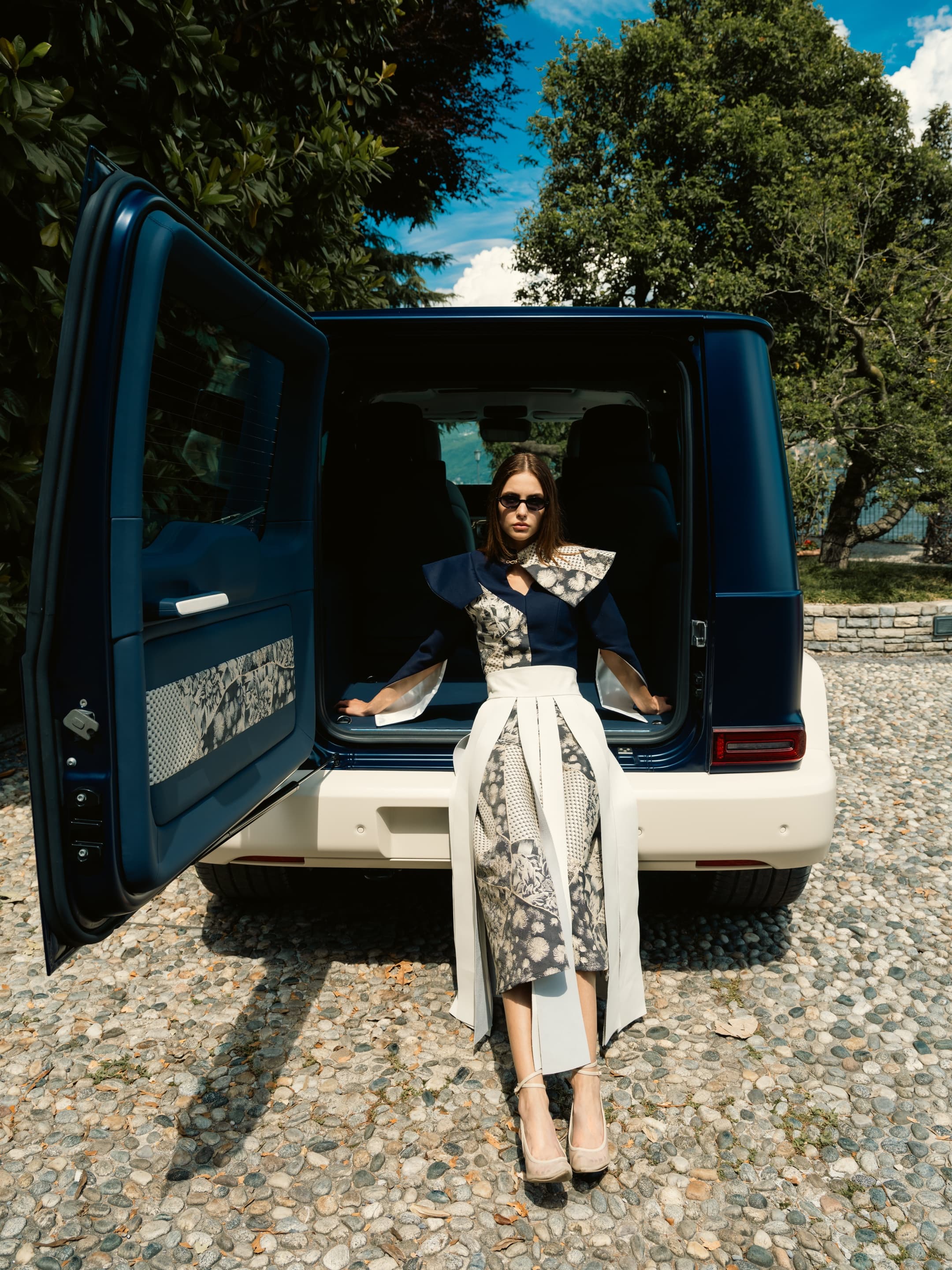 Model emerging from Kinsō coach door, navy and floral couture