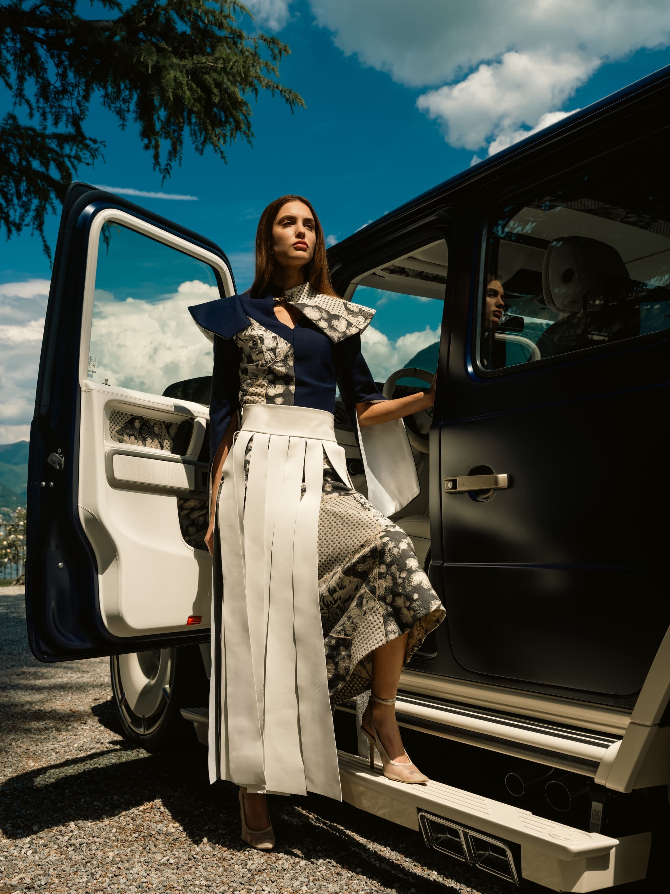 Model framed by Kinsō coach door, mid-shot