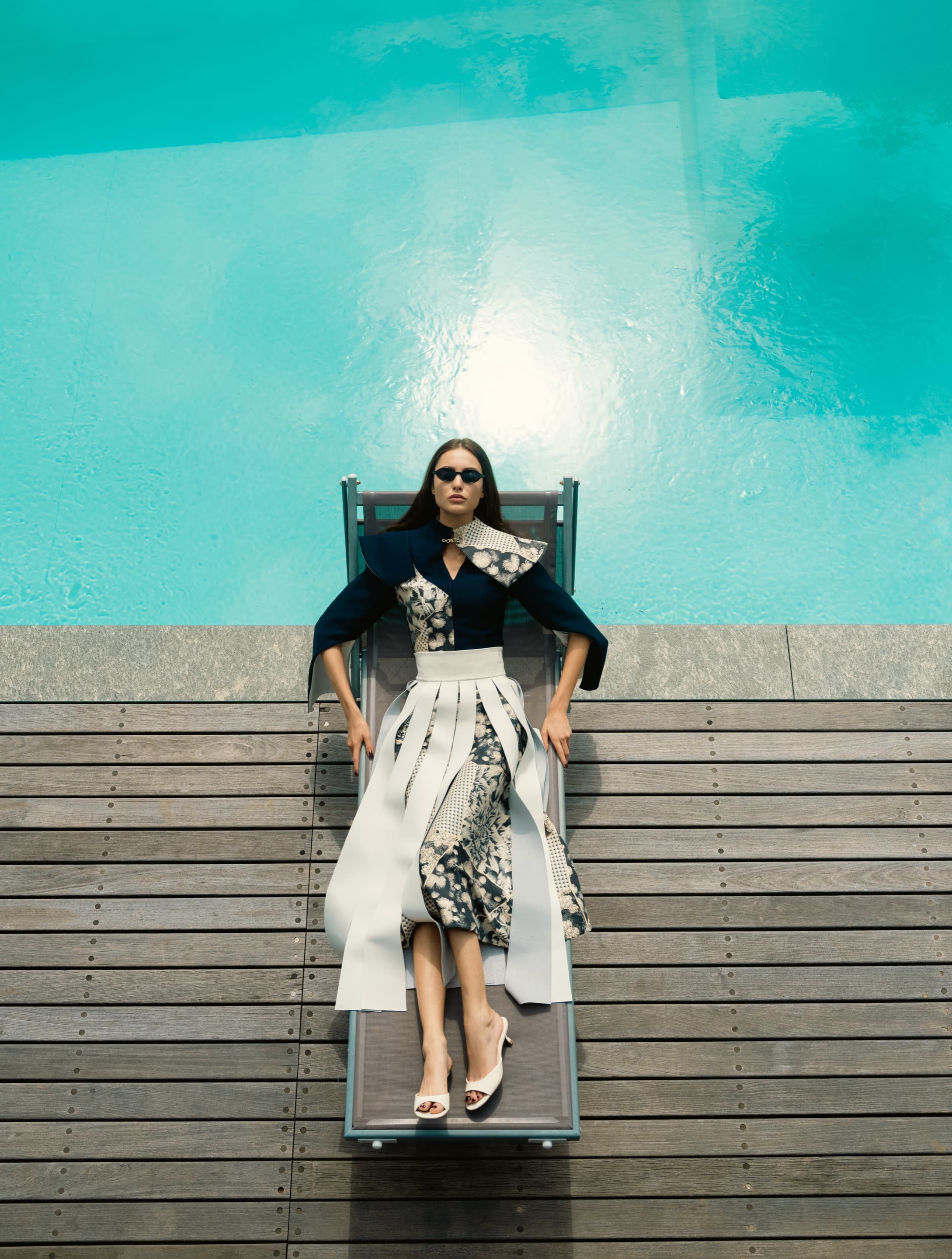 Top-down - model in Kinsō couture beside a private pool